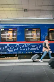 ÖBB Nightjet in the station with travelers in the foreground